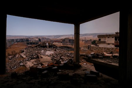 Views on 28th June 2019 around the destroyed city center of Shingal while a field fire rages south of the city 05