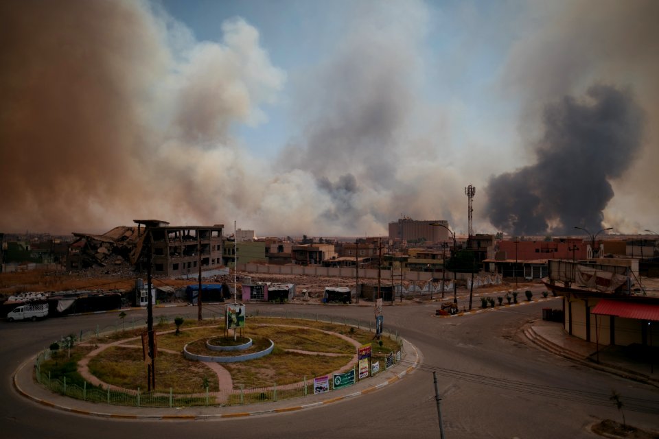 Views on 28th June 2019 around the destroyed city center of Shingal while a field fire rages south of the city 24