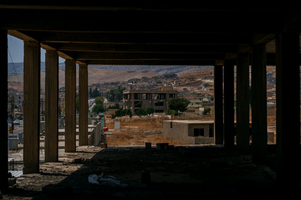 Views on 28th June 2019 around the destroyed city center of Shingal while a field fire rages south of the city 14