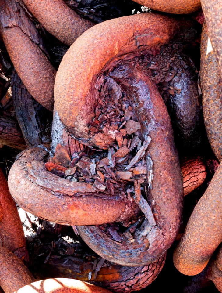 Very rusty chain shaded on a sunny day