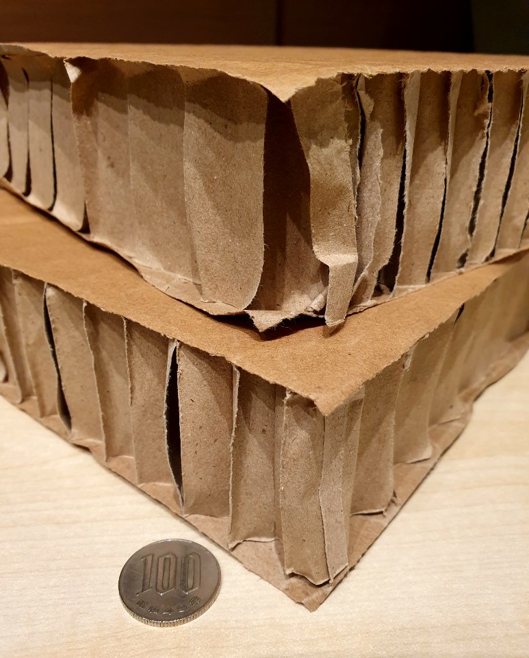 Very thick cardboard, a few centimeters. 100 yen coin for comparison