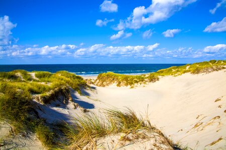 Clouds north sea sand photo