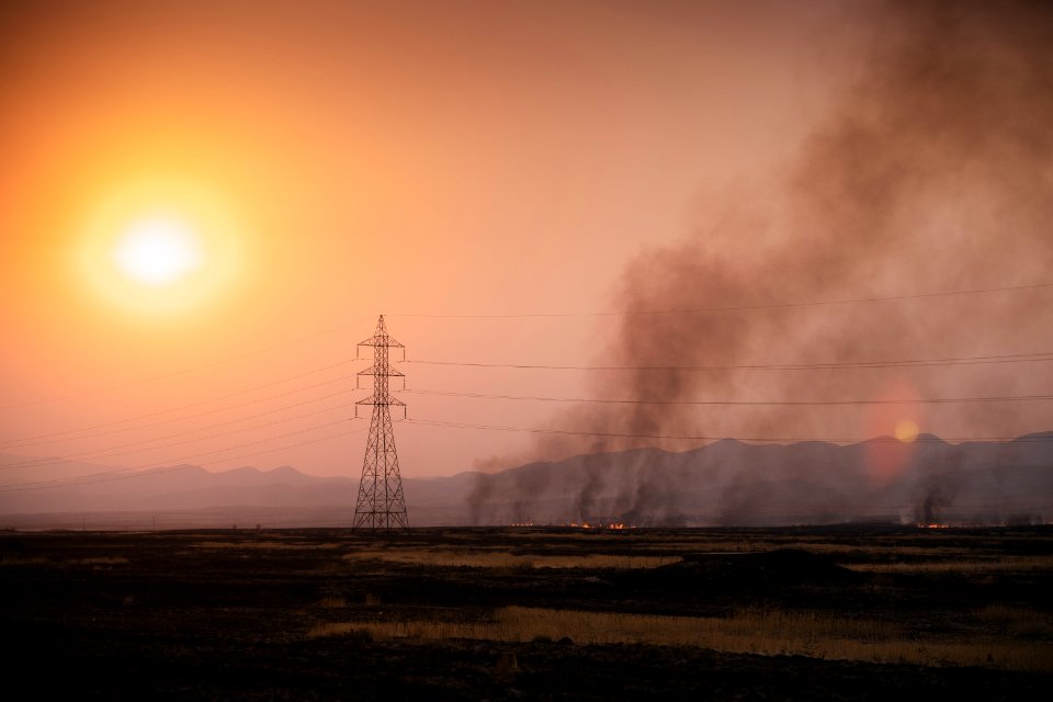 View at sunset of the smokey skyline in Sinjar during the 2019 fires that ravaged the region - 11
