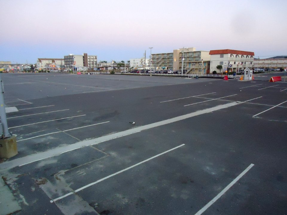 View from boardwalk looking at hotels and buildings and parking lot at Wildwood New Jersey