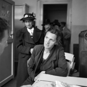 Vrouw in gespek met een hulpverlener Achter haar wachten andere vrouwen, Bestanddeelnr 900-4659
