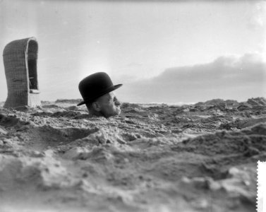 Vreemde situatie aan het Nederlandse strand, man met hele lichaam in het zand, Bestanddeelnr 910-3932 photo