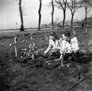 Vrouwen leggen bloemen op het graf van de Canadese militair HW Roszell, Bestanddeelnr 900-2648