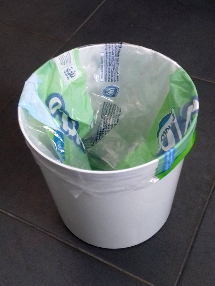 Waste bin with toilet tissue packaging foil