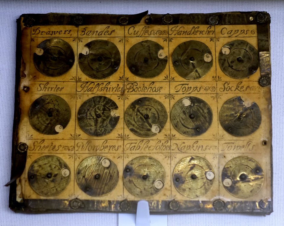 Washing tally, England, 1600-1700, oak board, brass, horn, printed sheet covered with talc - Museum, Haddon Hall - Bakewell, Derbyshire, England - DSC02956
