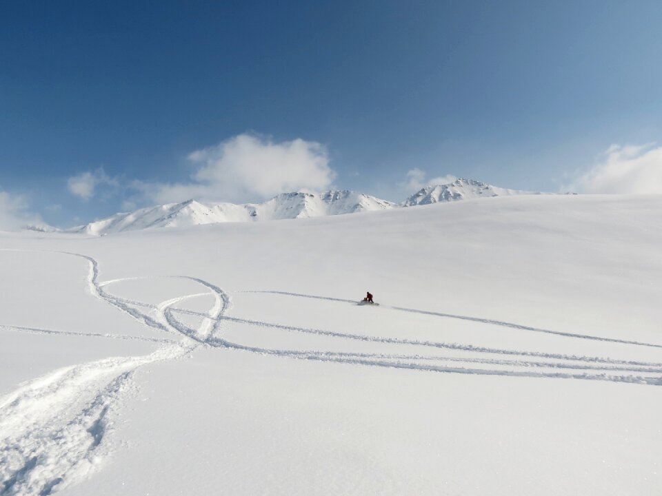 Travel by snowmobile footprints in the snow mountains photo