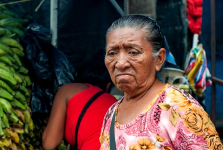 Wayuu woman with sad face in the market buying photo