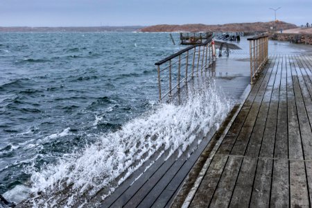 Waves crashing up through the boardwalk in Lysekil during Storm Ciara 3