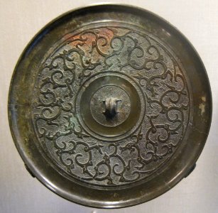 Warring States period bronze mirror with four dragons design, HAA