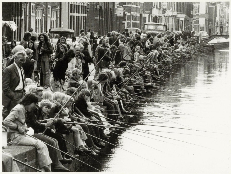 Viswedstrijd voor de jeugd in de Brouwersvaart zuidzijde, ziende naar het westen. NL-HlmNHA 54003541