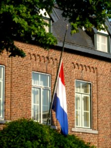 Vlag halfstok aan een huis tijdens de dag van nationale rouw op 23 juli 2014