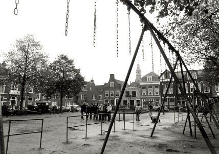 Wilsonsplein, oostzijde, ziende naar het oosten, met op de voorgrond de Speeltuin Centrum. Aangekocht in 1979 van fotograaf C. de Boer. - Negatiefnummer 18580 k 33. - Gepubliceerd in het Haa, NL-HlmNHA 54010752