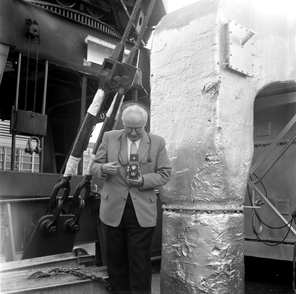 Willem van de Poll bezig met fotograferen met zijn Rolleicord in de haven van Wi, Bestanddeelnr 252-1680