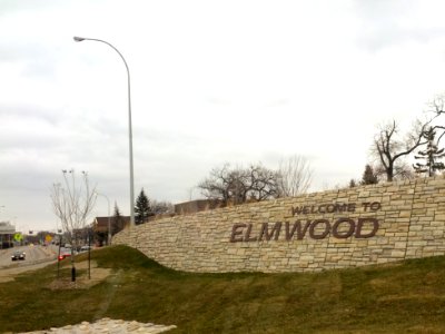 Welcome to Elmwood sign on embankment in Winnipeg, Manitoba