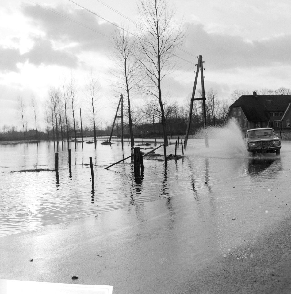 Wateroverlast in de Gelderse Vallei auto rijdend langs ondergelopen weiland, Bestanddeelnr 918-5504