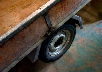 Wheel on an old wooden trailer photo