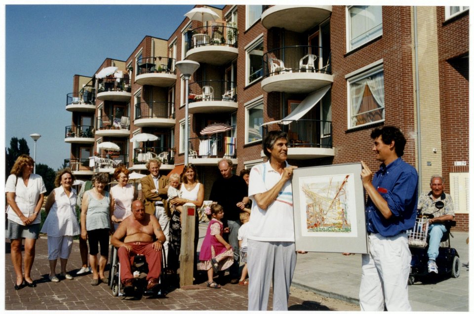 Wethouder J. Haverkort overhandigt een schilderij aan bewoners van een nieuw seniorencomplex in Parkwijk-Noord op het terrein van de voormalige woonschool. NL-HlmNHA 54036391