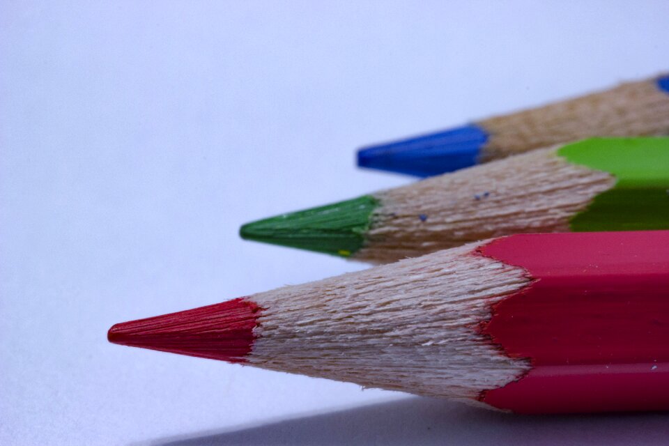Three color pencils light background close-up