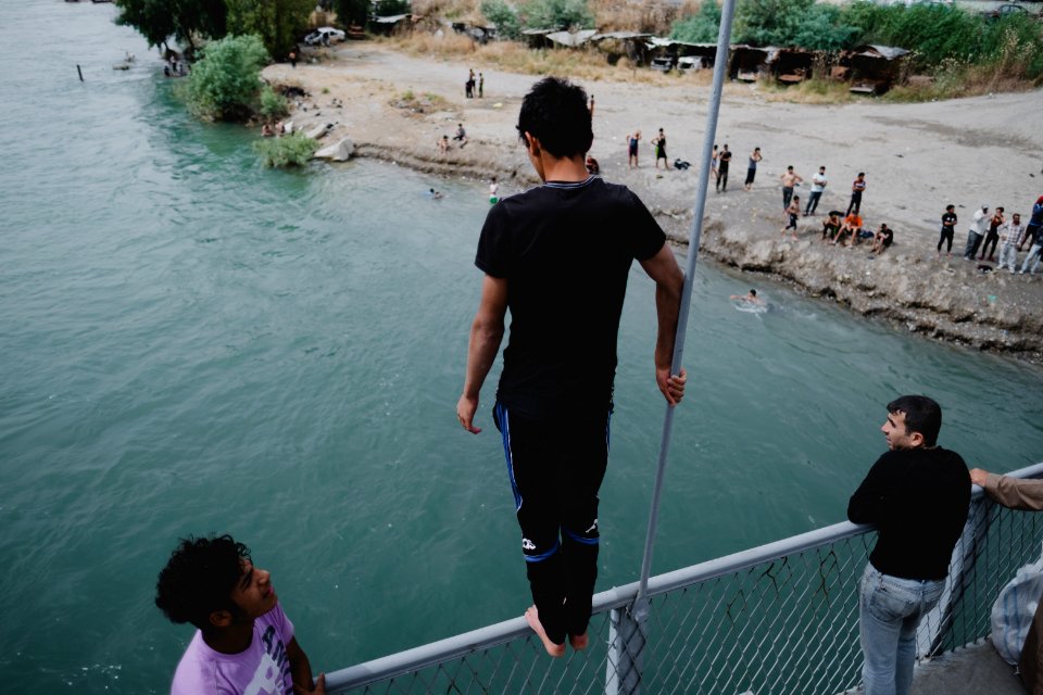Young men gathered at Mosul's "Old Bridge" over the Tigris River in summer of 2019 to jump into the water and escape summer heat 09