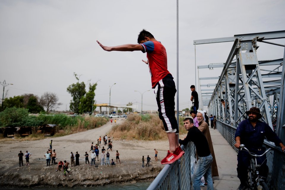 Young men gathered at Mosul's "Old Bridge" over the Tigris River in summer of 2019 to jump into the water and escape summer heat 03