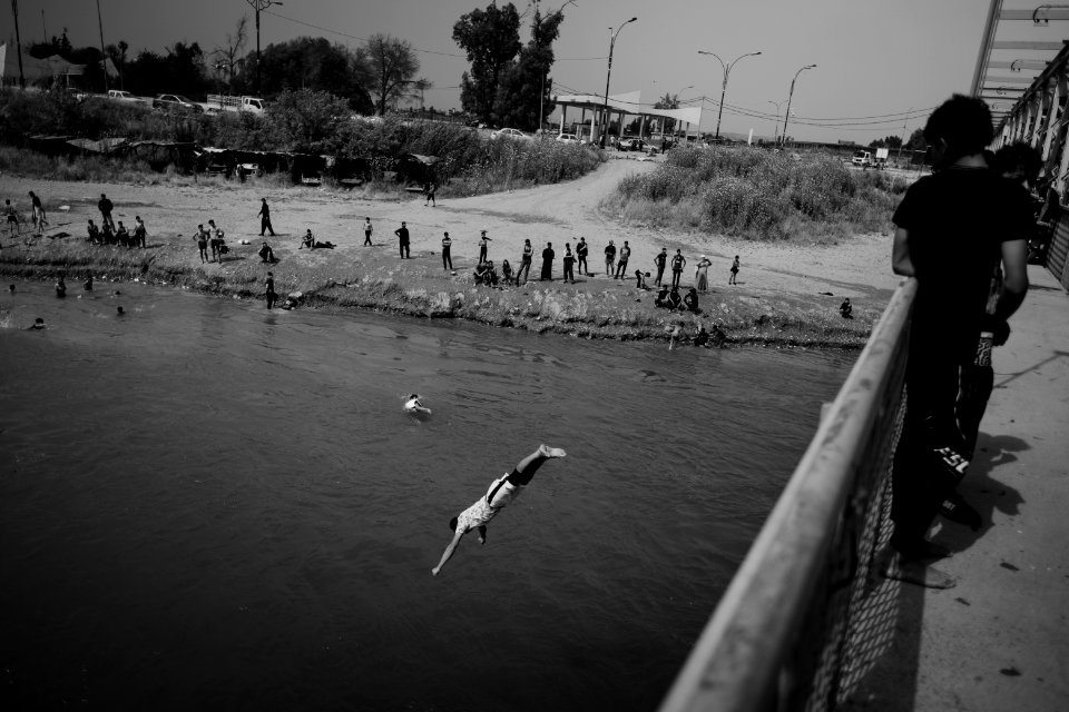 Young men gathered at Mosul's "Old Bridge" over the Tigris River in summer of 2019 to jump into the water and escape summer heat 20
