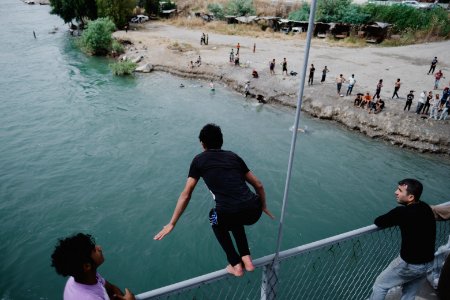 Young men gathered at Mosul's "Old Bridge" over the Tigris River in summer of 2019 to jump into the water and escape summer heat 11