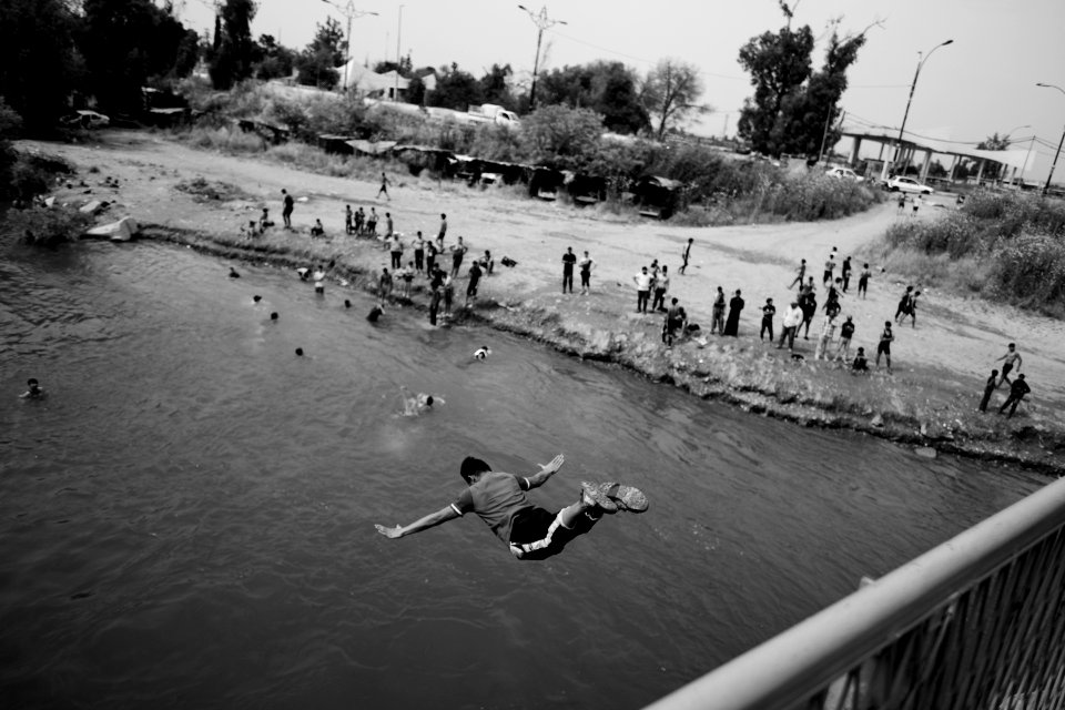 Young men gathered at Mosul's "Old Bridge" over the Tigris River in summer of 2019 to jump into the water and escape summer heat 07