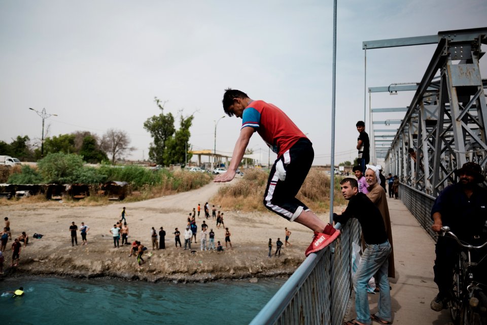 Young men gathered at Mosul's "Old Bridge" over the Tigris River in summer of 2019 to jump into the water and escape summer heat 04