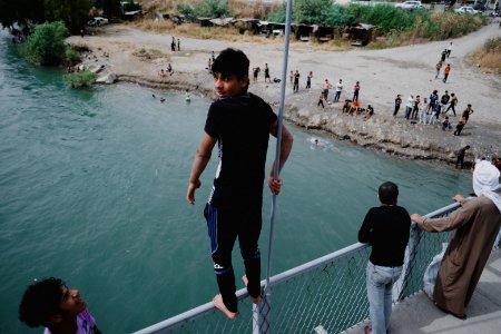 Young men gathered at Mosul's "Old Bridge" over the Tigris River in summer of 2019 to jump into the water and escape summer heat 08