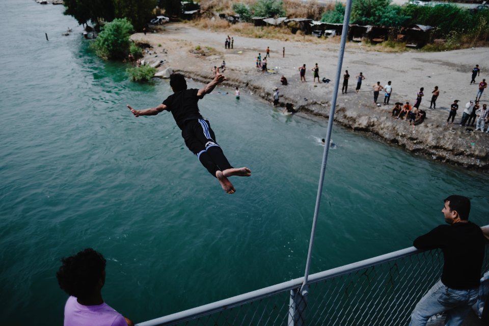Young men gathered at Mosul's "Old Bridge" over the Tigris River in summer of 2019 to jump into the water and escape summer heat 13