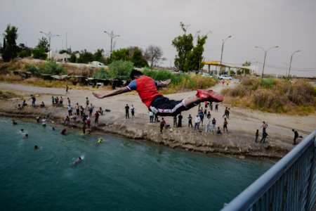 Young men gathered at Mosul's "Old Bridge" over the Tigris River in summer of 2019 to jump into the water and escape summer heat 06