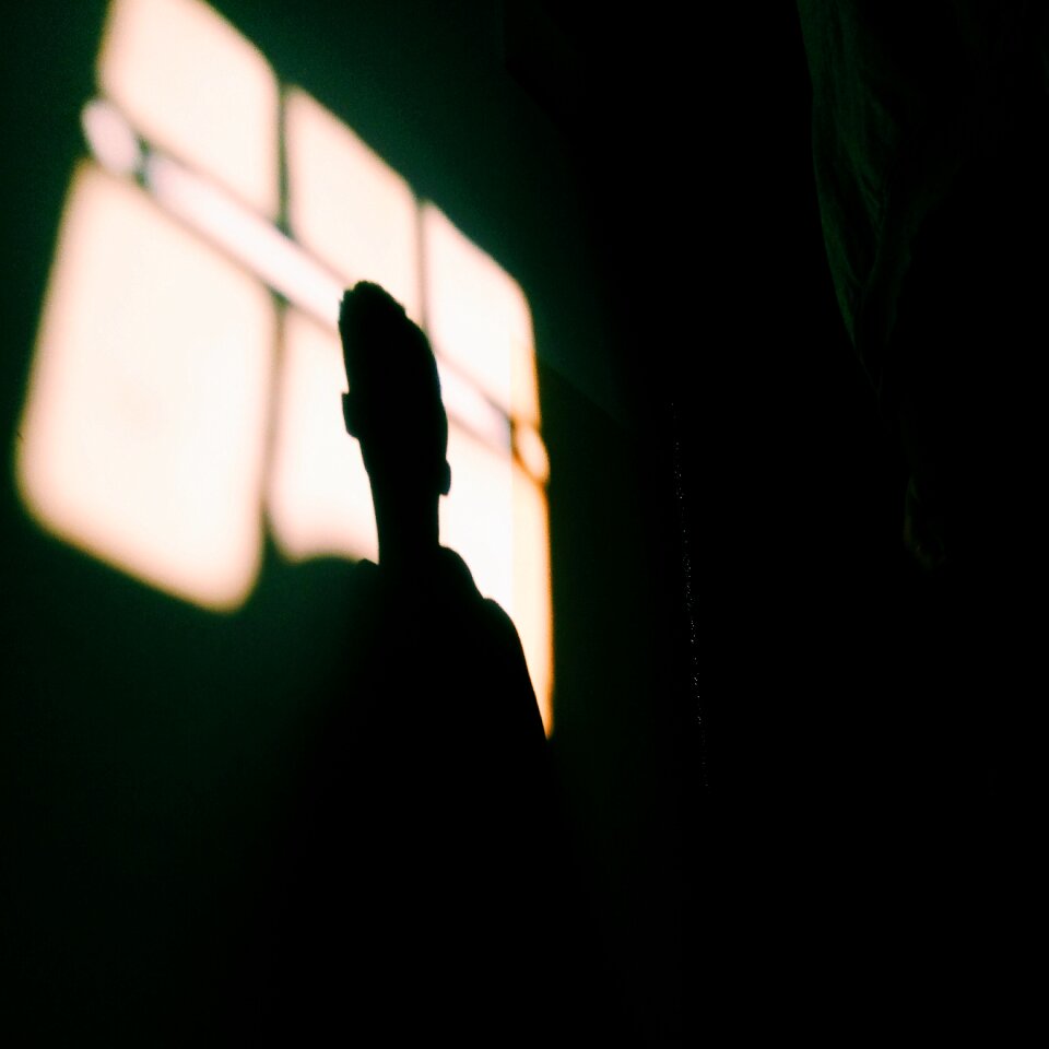 Silhouette man black room