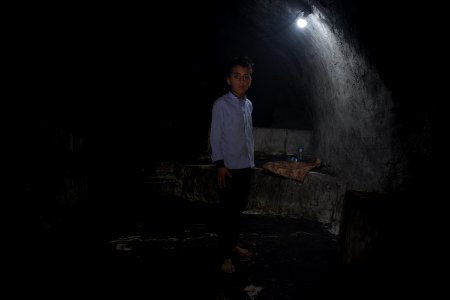 Young boy standing next to the shrine of Obakr at Lalish 10