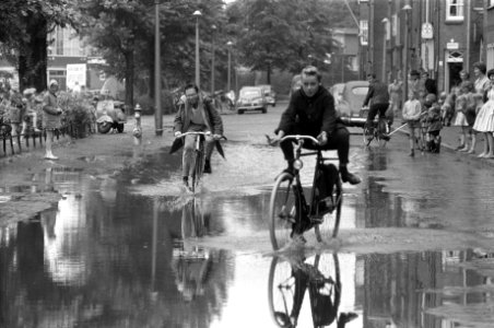 Wolkbreuk boven Amsterdam, kinderen rijden door de plassen, Bestanddeelnr 911-4963