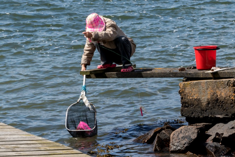 Woman fishing for shore crabs 3