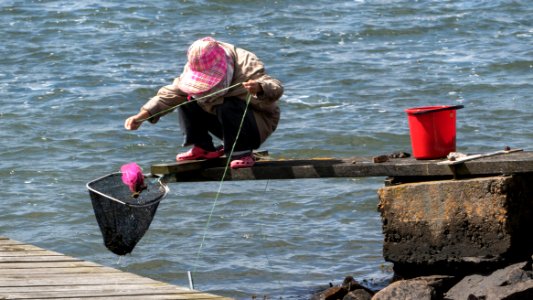 Woman fishing for shore crabs 5