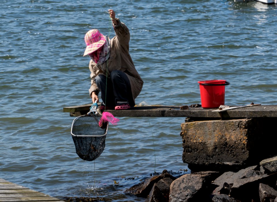 Woman fishing for shore crabs 4