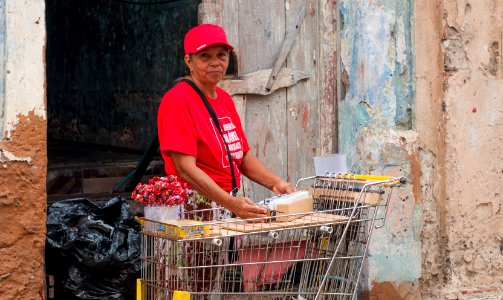 Woman selling cigars and lollipops