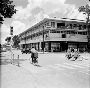 Winkelpand in Paramaribo met onder andere een fotowinkel en een rijwielenhandel., Bestanddeelnr 252-4943