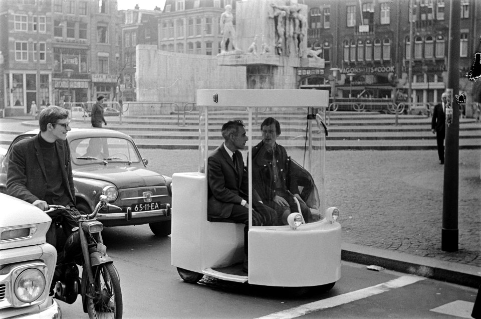 Witkar getoond door Provo-gemeenteraadslid Luud Schimmelpennink in het drukke ve, Bestanddeelnr 921-3827