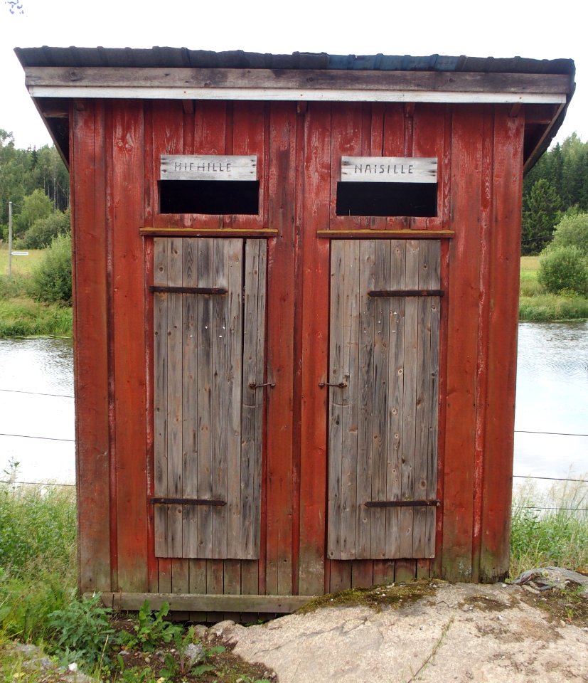Wooden latrine with doors for men and women