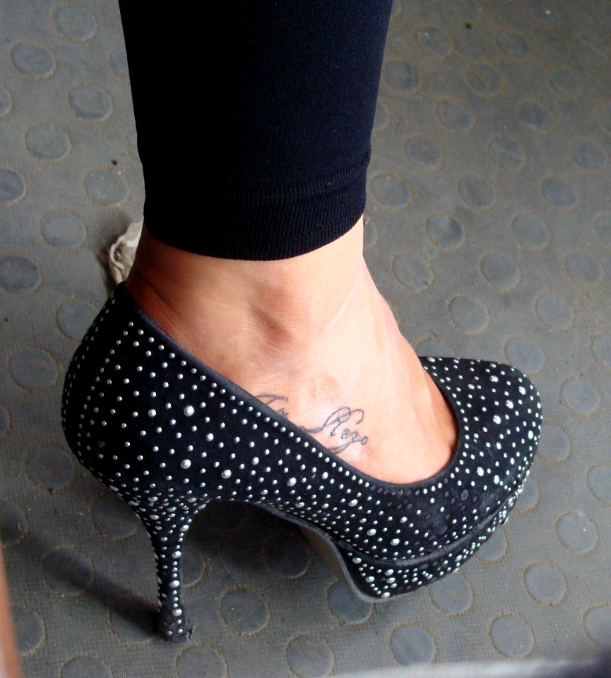 Women's leg with an inscription in the shoe