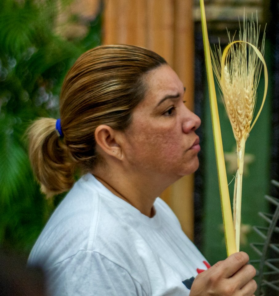Women pray for the blessing of her palm