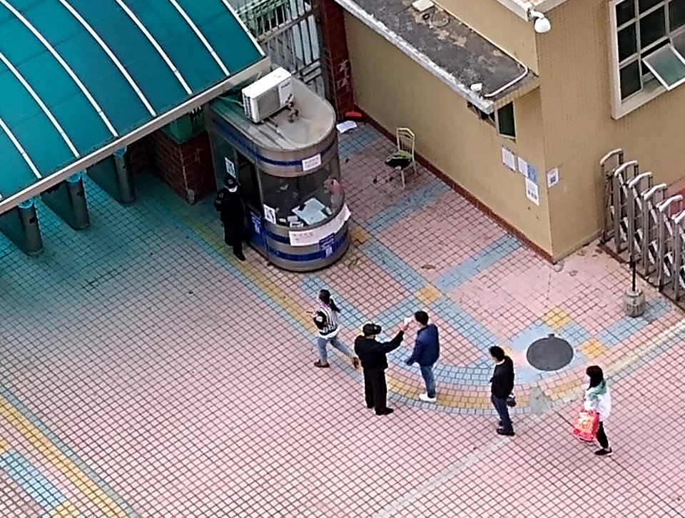 Workers having their temperatures taken as they enter an industrial park (cropped)