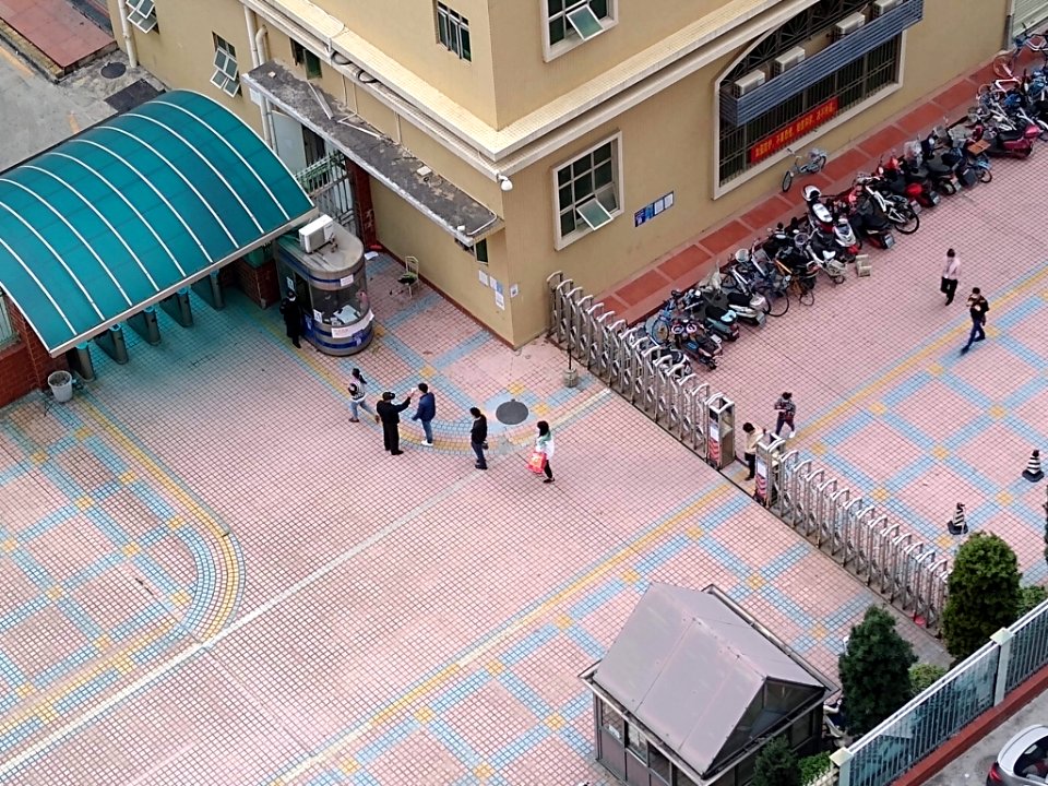 Workers having their temperatures taken as they enter an industrial park