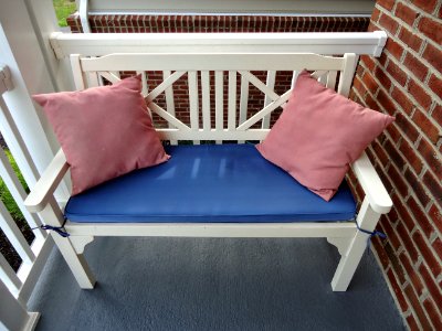 Bench with two pink pillows on a front stoop in Maryland photo